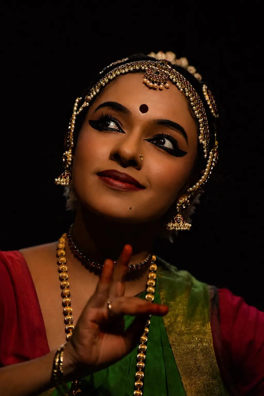 Devi Nandana performing Bharatanatyam on stage.