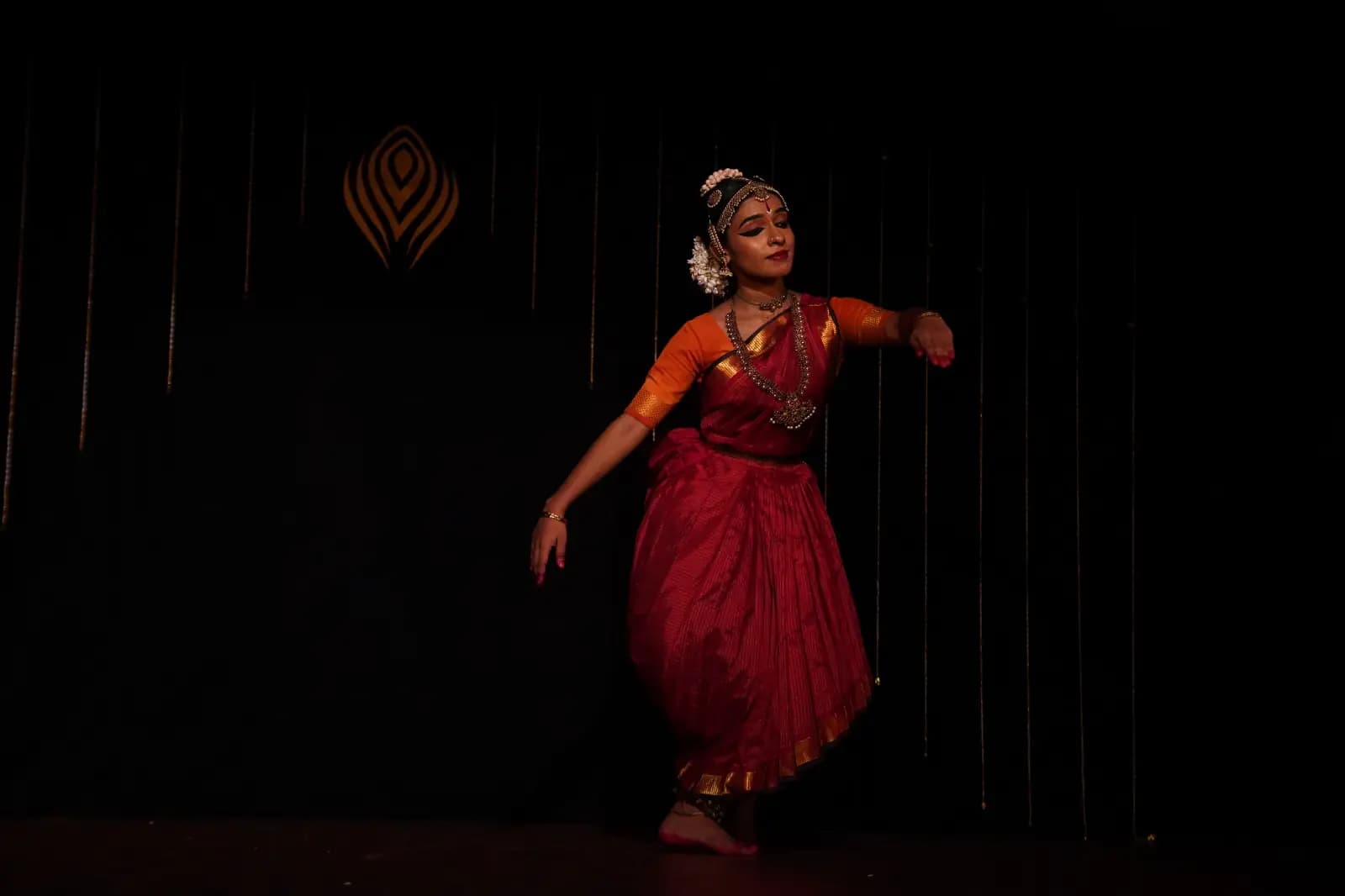 Devi Nandana performing Bharatanatyam on a public stage.